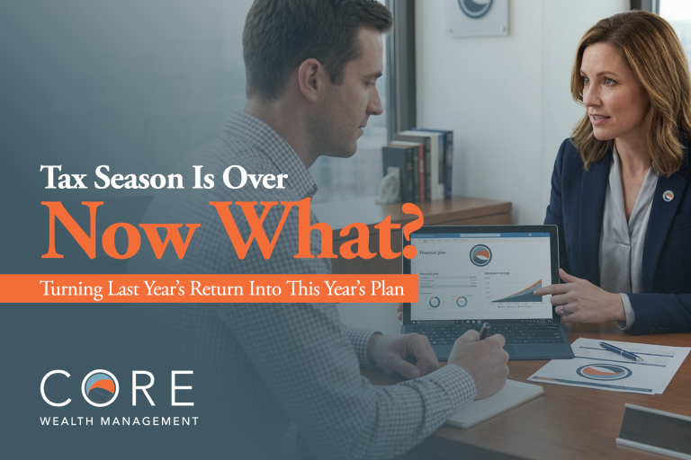 Man and woman financial advisors discussing a "Tax Season Is Over—Now What?" presentation on a screen.